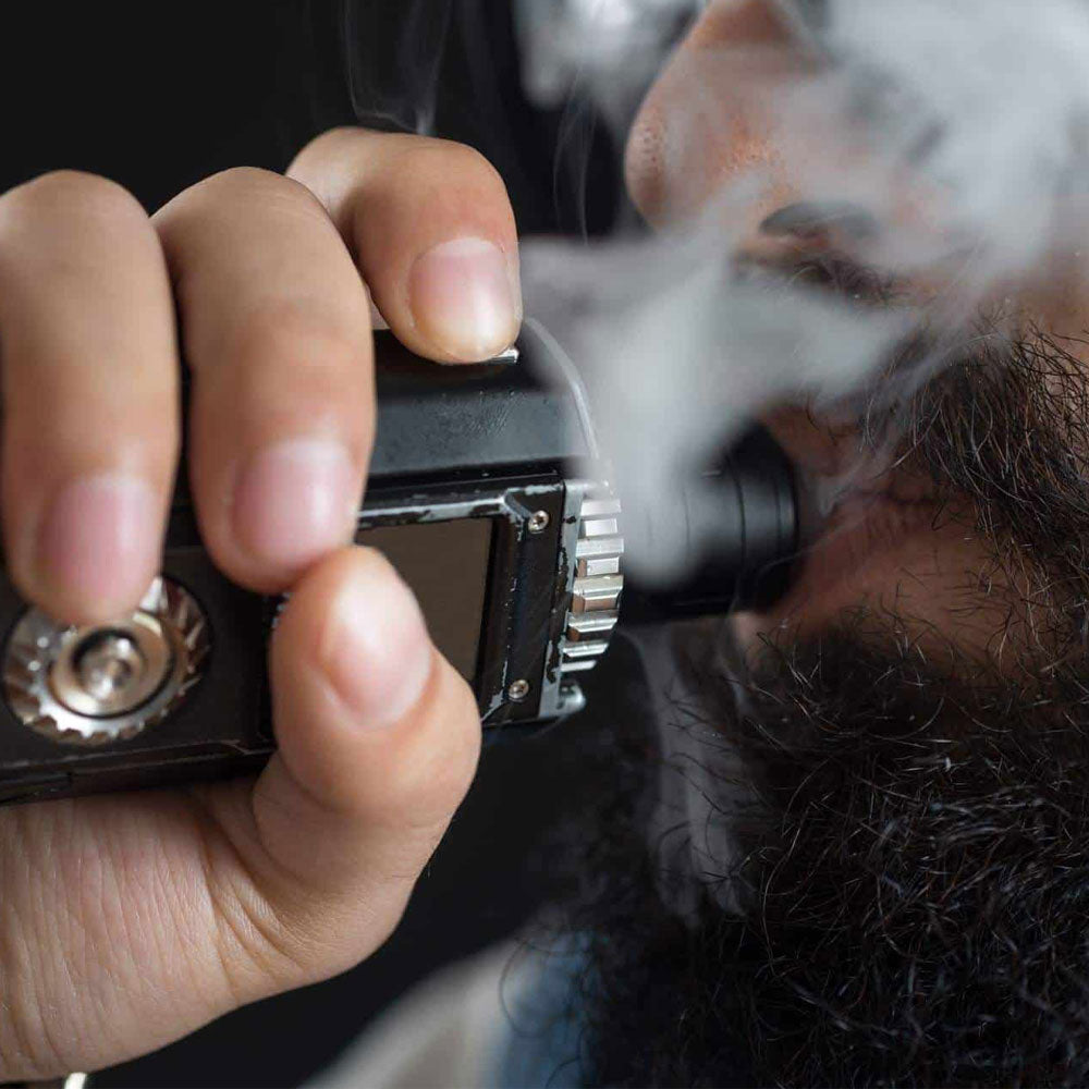 A man vaping from a electronic vaporizer