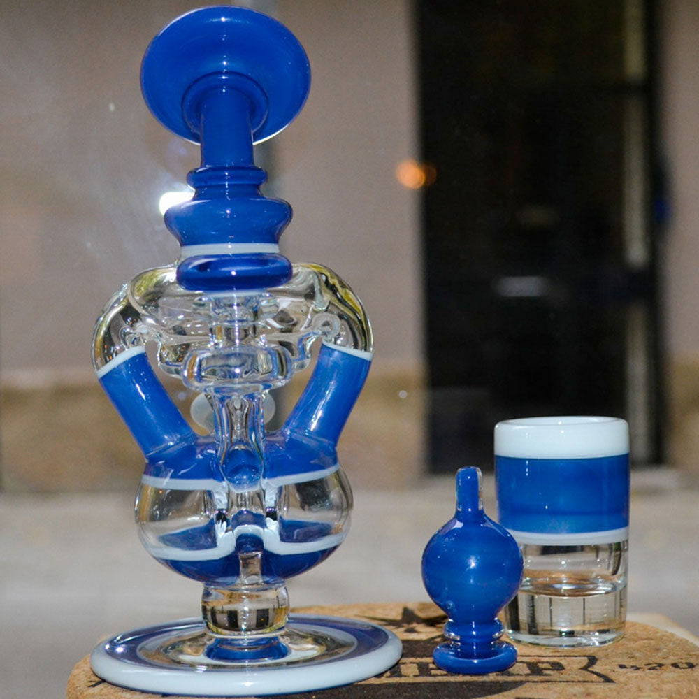 A wax dab rig sitting on a dab mat