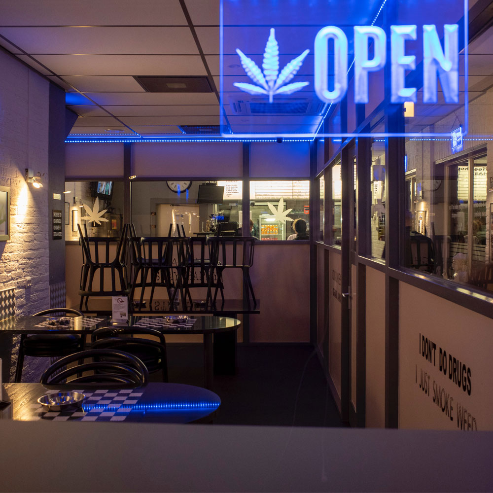 Cannabis dispensary with blue neon light with open sign