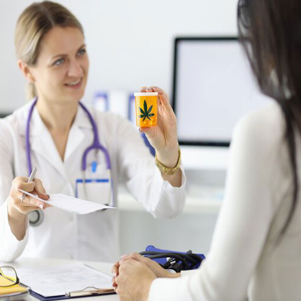 Attendant presents a CBD bottle to a woman at a dispensary