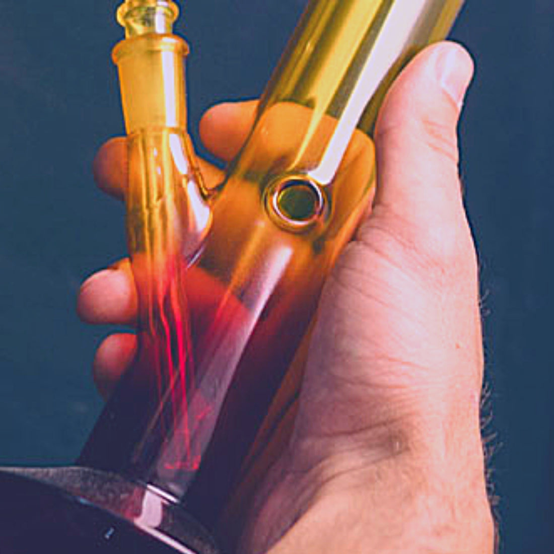 hand holding bong with carb