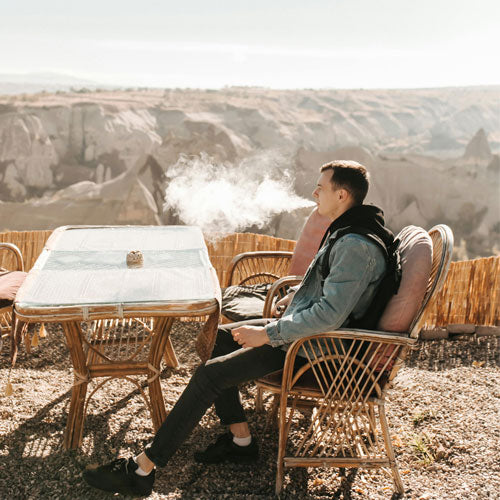 man sitting and vaping