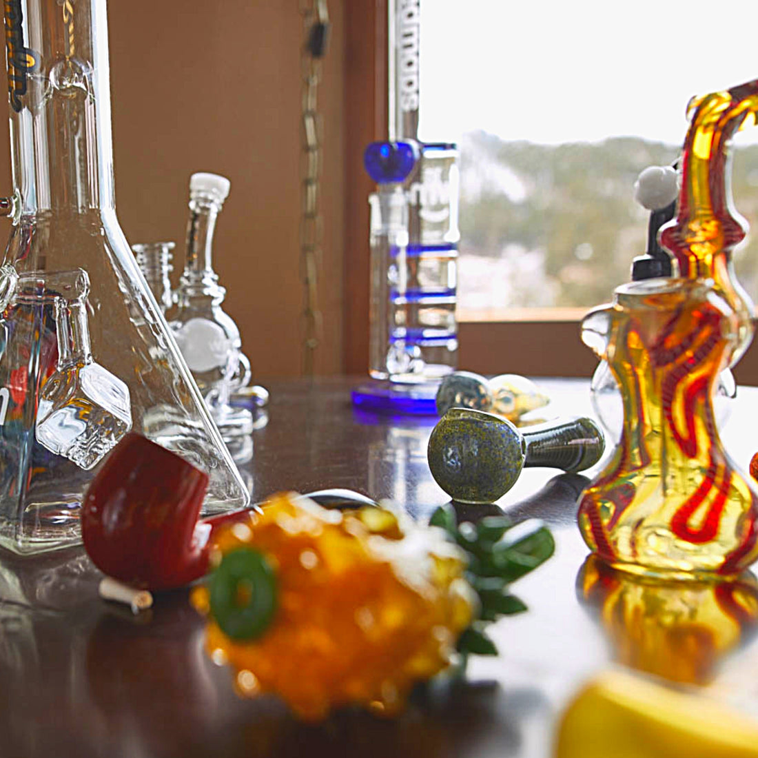 Random glass pipes bongs bubblers scattered on table