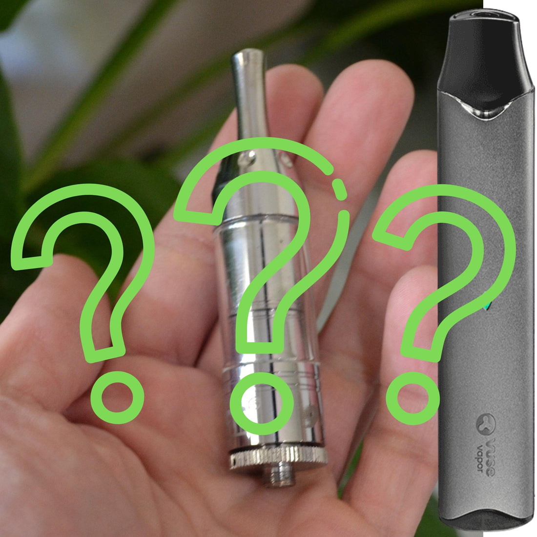 Hand holding vape tank with vaporizer next to it